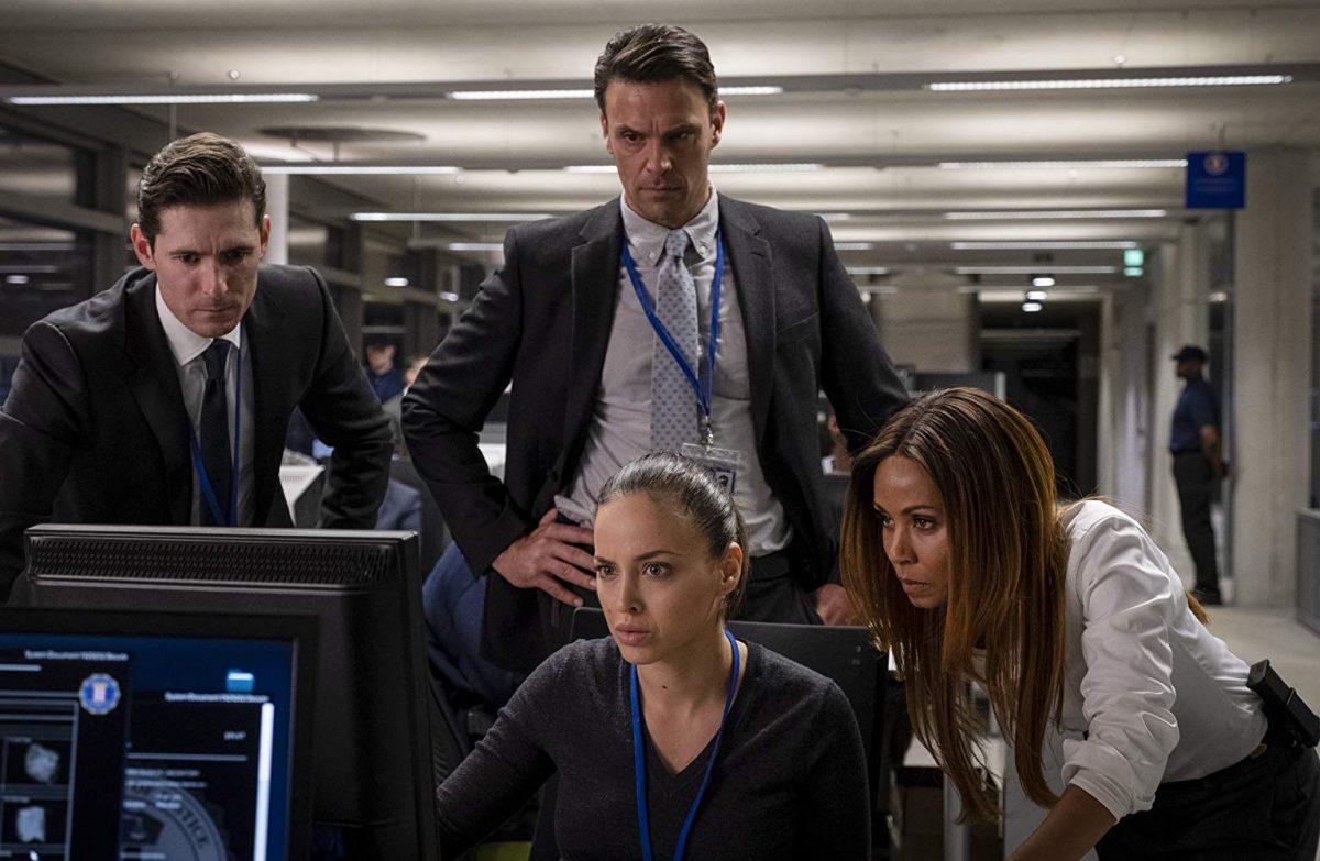 Joseph Millson (center), Sapir Azulay (seated, center), and Jada Pinkett Smith (right) star in “Angel Has Fallen.” (Jack English/Summit Entertainment)