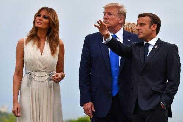 French President Emmanuel Macron (R) gestures past President Donald Trump (C) and First Lady Melania Trump at the Biarritz lighthouse, southwestern France, on Aug. 24, 2019. (Nicholas Kamm/AFP/Getty Images)