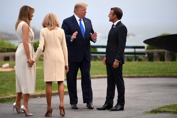 French President Emmanuel Macron (R) and his wife Brigitte Macron (2nd L) welcome President Donald Trump (2nd R) and First Lady Melania Trump (L) ahead of a working dinner at the Biarritz lighthouse in Biarritz, France on Aug. 24, 2019. (Neil Hall/Pool/Getty Images)