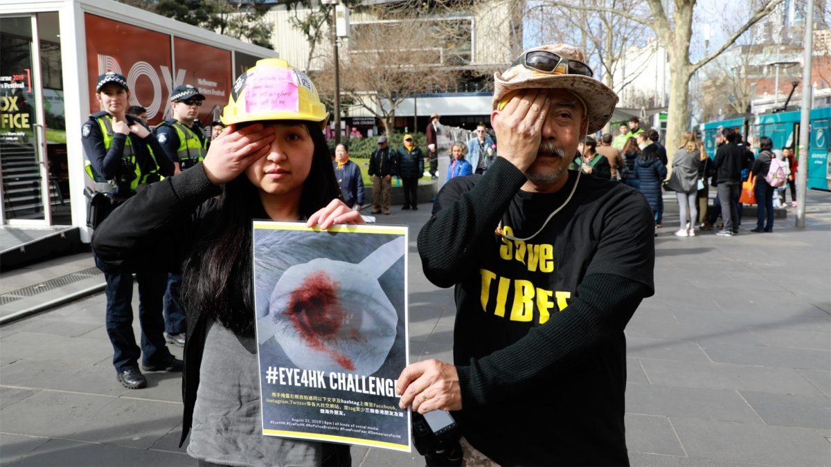 Pro-Hong Kong protesters in Melbourne holding a poster at a Hong Kong rally in Melbourne, Australia on 25 August 2019. (Grace Yu/Epoch Times)