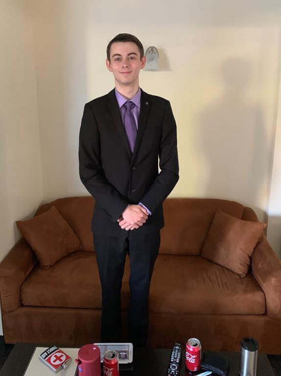 Bryer Schmegelsky poses in a new suit he bought with his second paycheque from Walmart in this June 29 handout photo provided by his father. (Al Schmegelsky/The Canadian Press)
