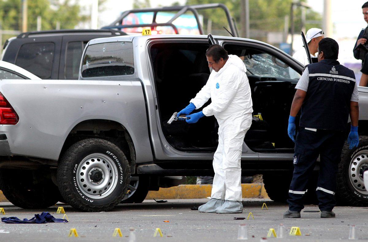 Forensic personnel work at a scene where five alleged criminals died during a confrontation with security forces in Tlajomulco, Jalisco state, Mexico, on Feb. 8, 2019. (ULISES RUIZ/AFP/Getty Images)