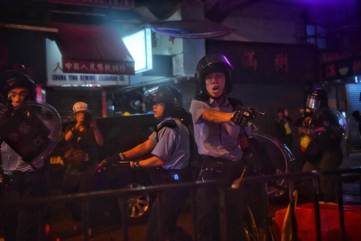 Viral Image of Unarmed Protester Pleading With Gun-Wielding Police Draws ‘Tank Man’ Comparisons