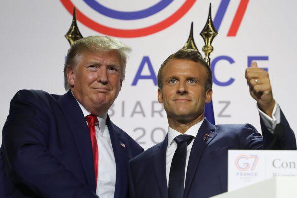 France's President Emmanuel Macron (R) and US President Donald Trump shake hands during a joint-press conference in Biarritz, south-west France on Aug. 26, 2019. (Ludovic Marin/AFP/Getty Images)