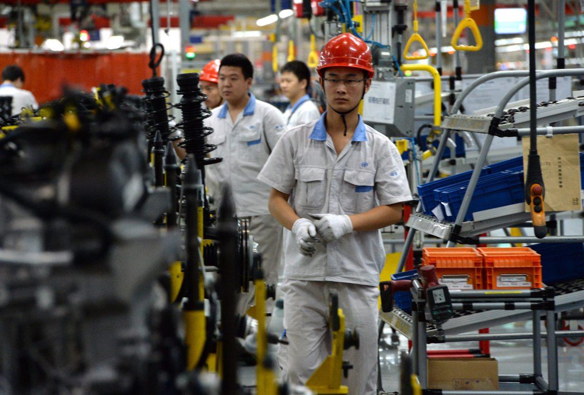 Chinese auto workers on the assembly line at the FAW-Volkswagen plant in Chengdu, in southwest China's Sichuan Province, on July 6, 2014. (Got Chai/AFP via Getty Images)