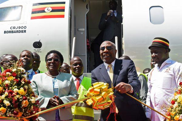 Ugandas Prime Minister Ruhakana Rugunda (2R) flanked by Minister of World and Transport Eng. Monica Azuba Ntege (2L) and the State Minister for Tourism Godfrey Kiwanda (R) take part in the launching ceremony of Uganda Airlines maiden flight to Jomo Kenyatta International Airport in Nairobi on Aug. 27, 2019. (ISAAC KASAMANI/AFP/Getty Images)