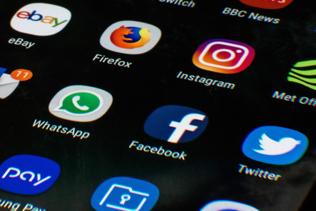 A mobile phone screen displays the icons for the social networking apps Facebook, Twitter, and Instagram on March 22, 2018. (Oli Scarff/AFP/Getty Images)