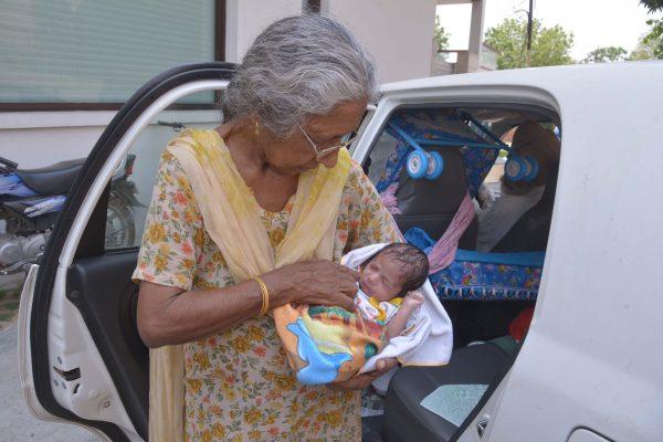 Indian mother Daljinder Kaur, 70, poses for a photograph upon arriving home as she holds her newborn baby boy Arman on May 11, 2016. (NARINDER NANU/AFP/Getty Images)