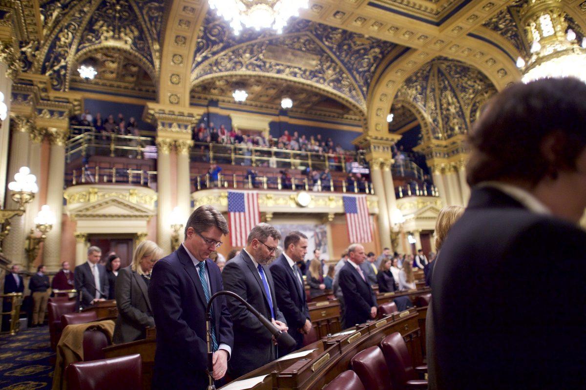 Attendees pray before electors cast their votes in the House of Representatives chamber of the Pennsylvania Capitol Building December 19, 2016 in Harrisburg, Pennsylvania. (Mark Makela/Getty Images)