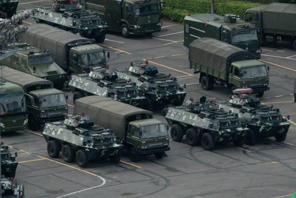 Trucks and armored personnel carriers are parked at the Shenzhen Bay stadium in Shenzhen, bordering Hong Kong in China's southern Guangdong Province on Aug. 16, 2019. (STR/AFP/Getty Images)