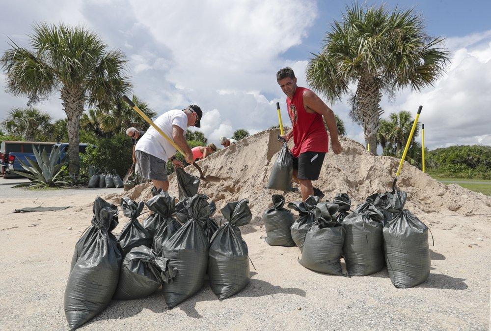 Residents of Flagler Beach, Fla., fill sandbags to help protect their homes in preparation for Hurricane Dorian on Aug. 30, 2019. (John Raoux/AP Photo)
