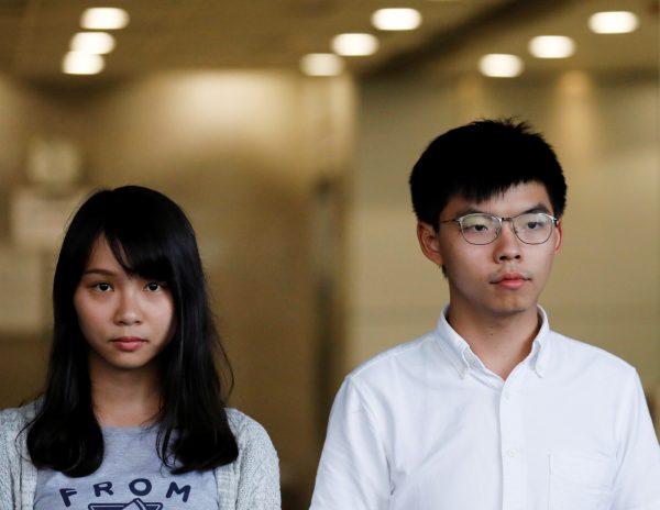 Pro-democracy activists Joshua Wong and Agnes Chow leave the Eastern Court after being released on bail in Hong Kong, on Aug. 30, 2019. (Anushree Fadnavis/Reuters)