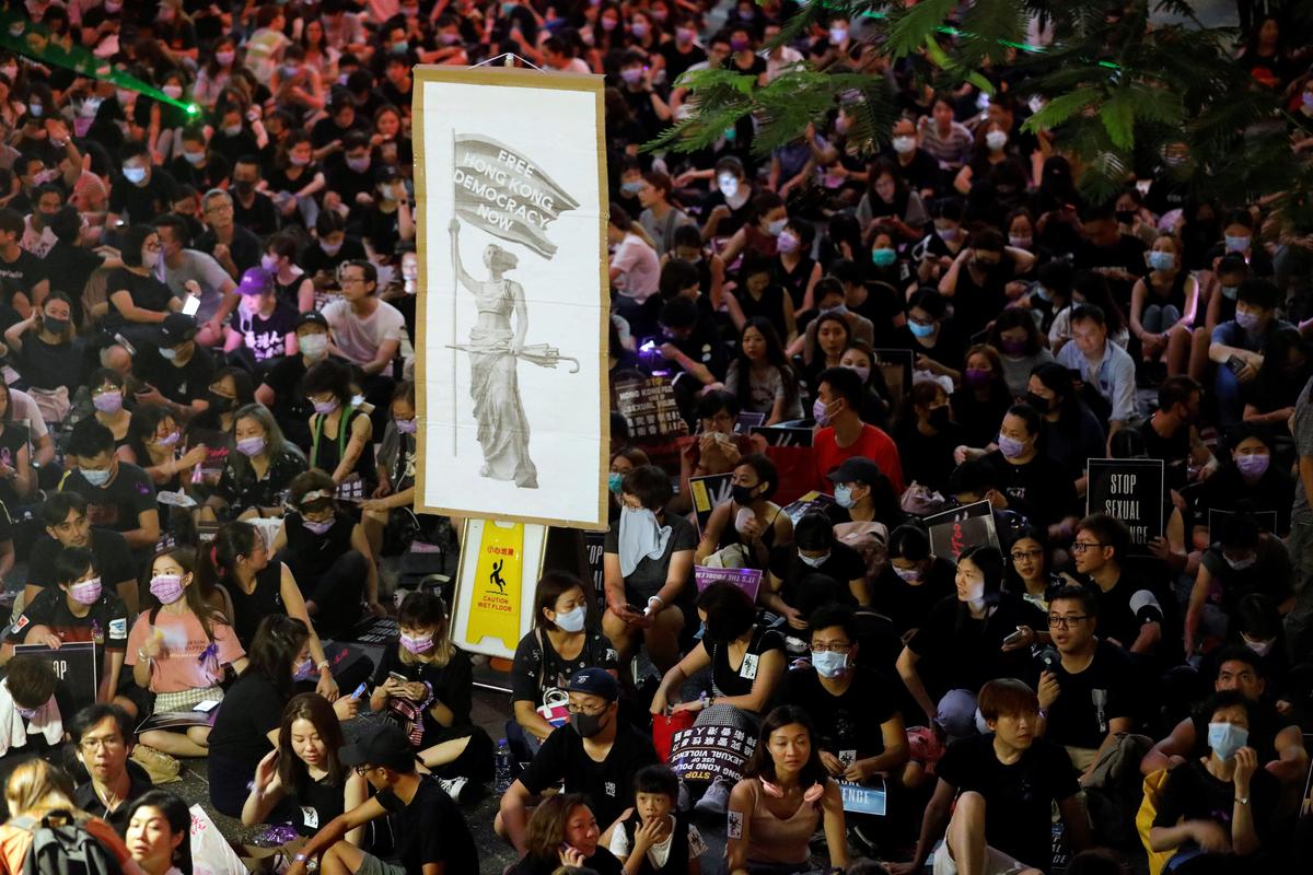 Protesters carry placards as they gather to condemn alleged sexual harassment of a detained demonstrator at a police station, in Hong Kong, China on Aug. 28, 2019. (Anushree Fadnavis/Reuters)