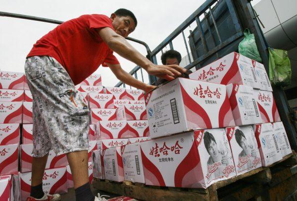 Chinese workers load bottles of Wahaha drinking water onto a truck for shipment. (Mark Ralston/AFP/Getty Images)