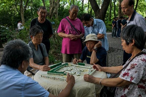 Chinese elderly people play Mahjong in a public park in Shanghai, China. (Chandan Khanna/AFP/Getty Images)