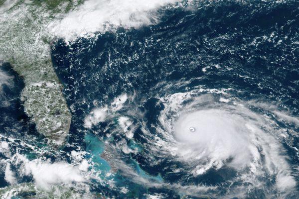 Hurricane Dorian, right, churning over the Atlantic Ocean, on Aug. 31,2019. (NOAA via AP)
