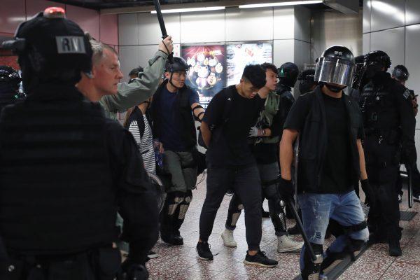 Riot police detain a man inside Prince Edward Mass Transit Railway (MTR) station after anti-extradition bill protest in Hong Kong, on Aug. 31, 2019. (Tyrone Siu/Reuters)