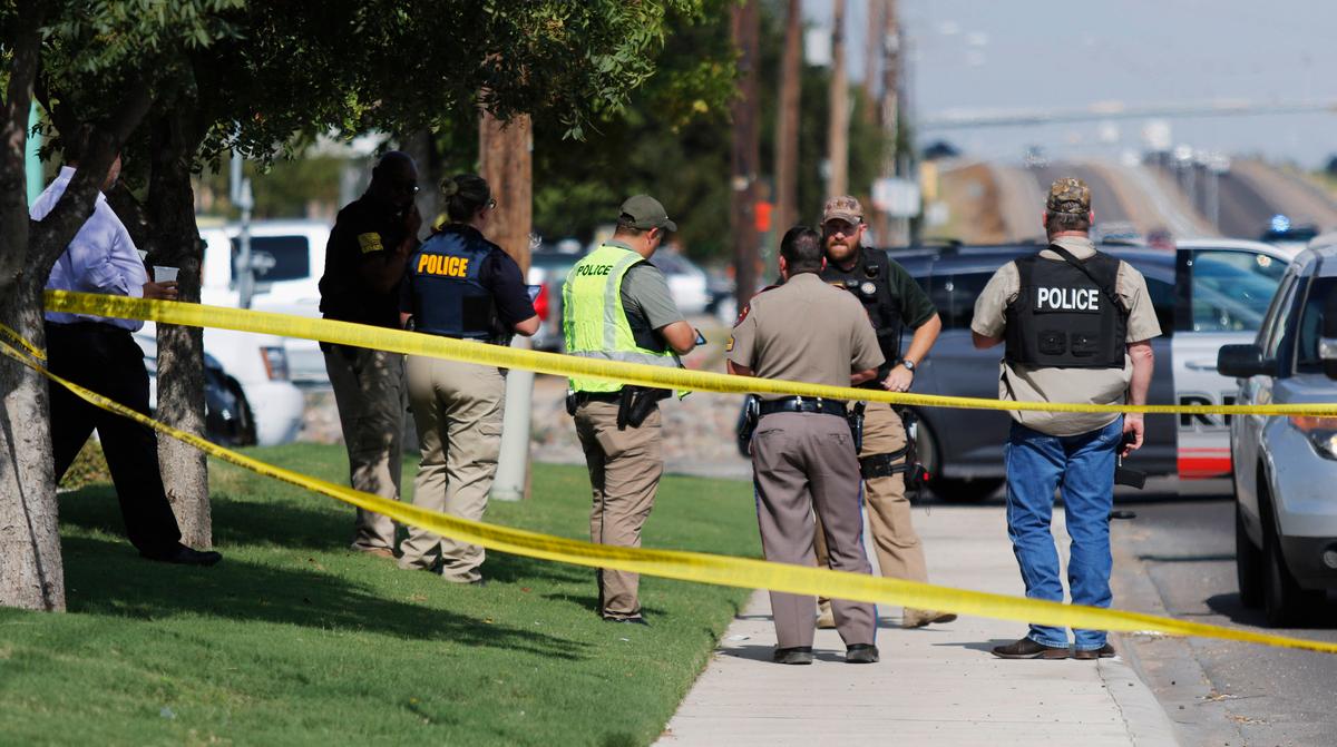 Authorities cordon off a part of the sidewalk in the 5100 block of E. 42nd Street in Odessa, Texas, on Aug. 31, 2019. (Mark Rogers/Odessa American via AP)