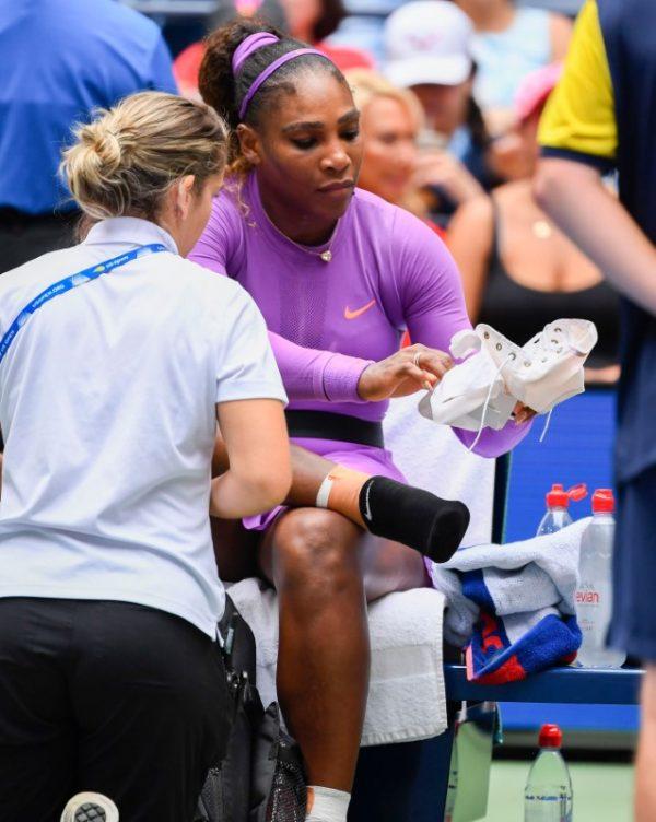 Serena Williams of the USA is treated for an injury between games against Petra Martic of Croatia in the fourth round on day seven of the 2019 U.S. Open tennis tournament at USTA Billie Jean King National Tennis Center on Sept. 1, 2019. (Robert Deutsch-USA TODAY Sports via Reuters)