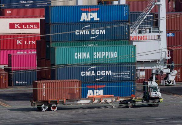 A truck passes by shipping containers at the Port of Los Angeles after tariffs on Chinese imports were imposed by President Donald Trump, in Long Beach, California on Sept. 1, 2019. (Mark Ralston/AFP/Getty Images)