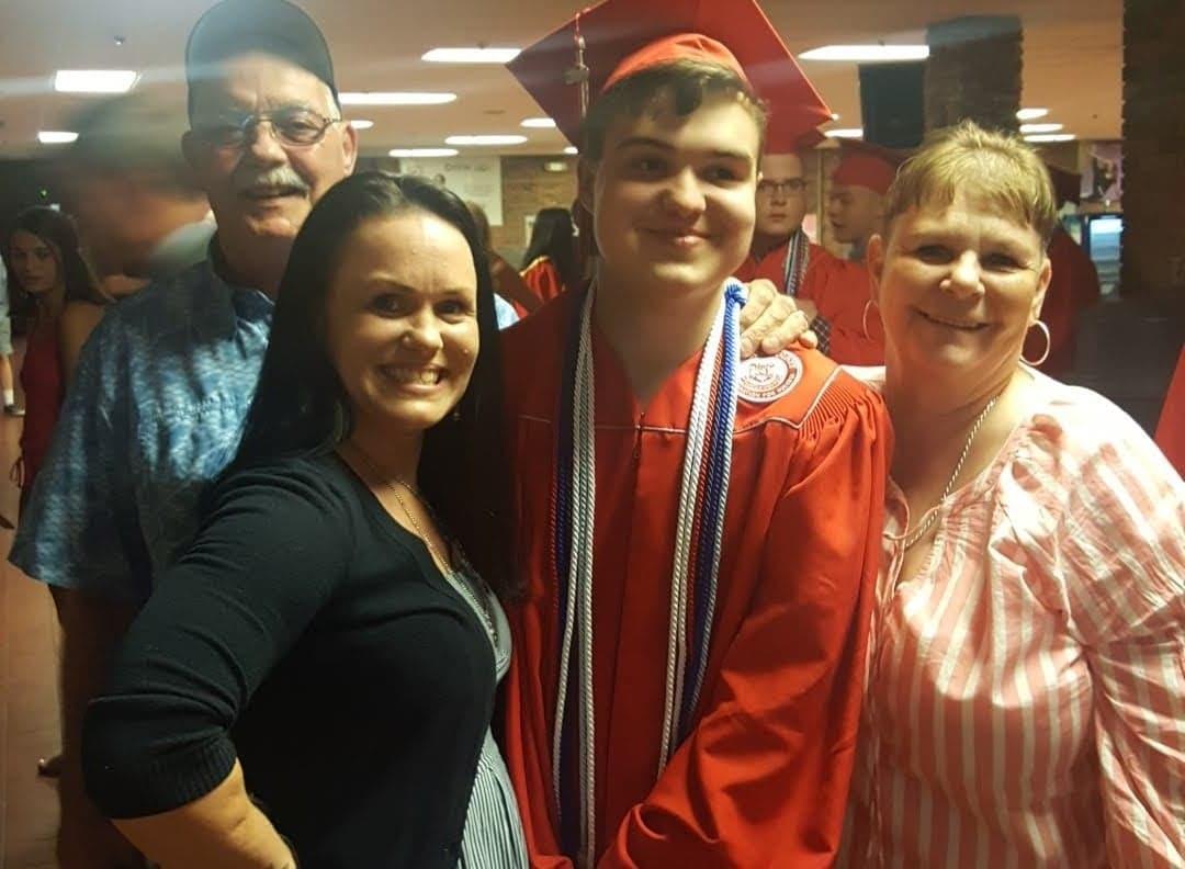 Michael Ardt (2nd R) with his mother Janice (2nd L) and his grandparents during his high school graduation ceremony. (Courtesy of Janice Ardt)