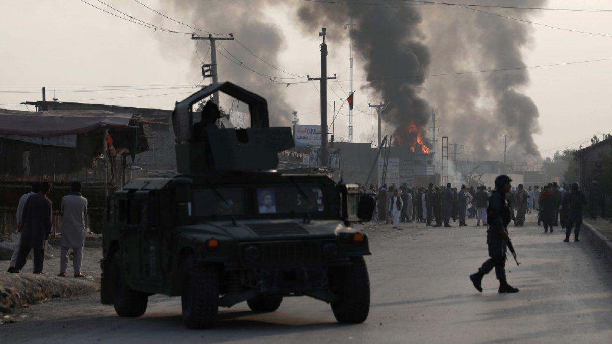 Policemen keep watch as angry Afghan protesters burn tires and shout slogans at the site of a blast in Kabul, Afghanistan on Sept. 3, 2019. (Omar Sobhani/Reuters)
