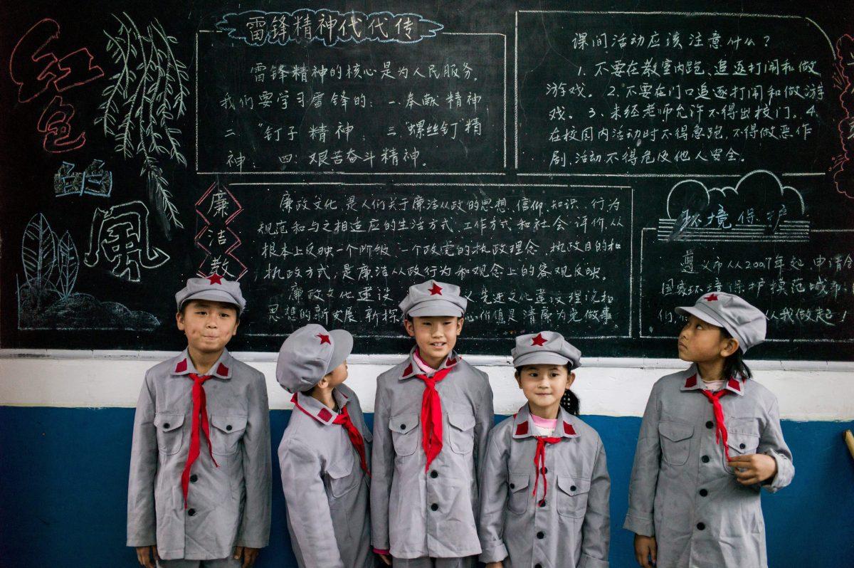 Students pose in front of a blackboard at the Yang Dezhi “Red Army” elementary school in Wenshui, Xishui country in Guizhou Province, China, on Nov. 7, 2016. (Fred Dufour/AFP/Getty Images)