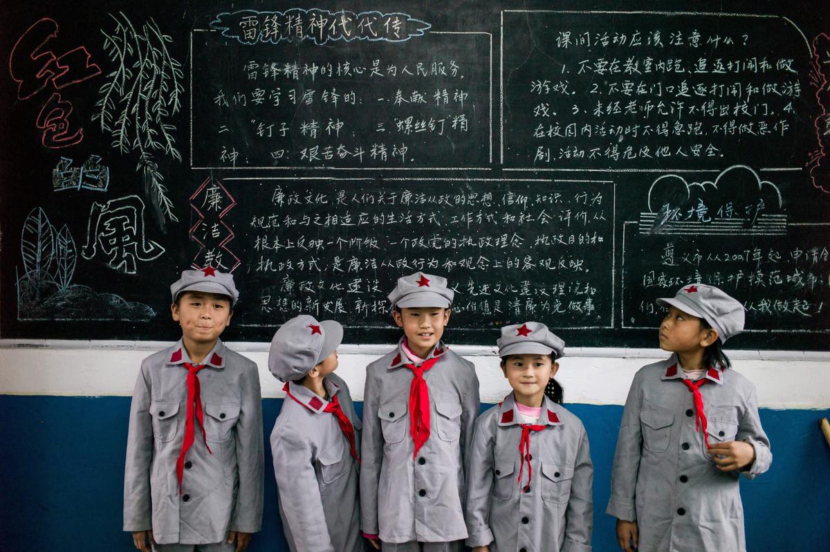 Students pose in front of a blackboard at the Yang Dezhi "Red Army" elementary school in Wenshui, Xishui County in Guizhou Province, China on Nov. 7, 2016. (Fred Dufour/AFP/Getty Images)