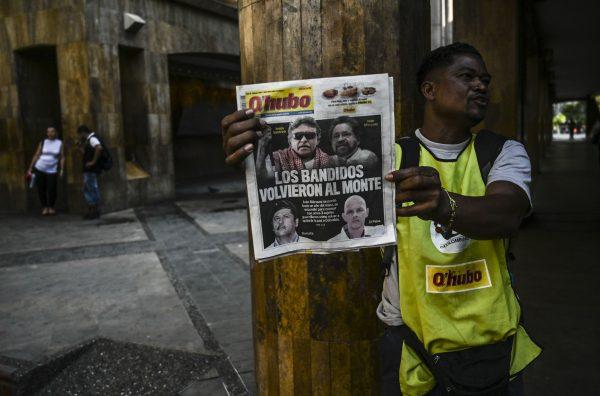 A vendor sells a newspaper in Medellin, Colombia, on Aug. 30, 2019, showing pictures of leaders of Marxist guerrilla groups on its cover. (Joaquin Sarmiento/AFP/Getty Images)