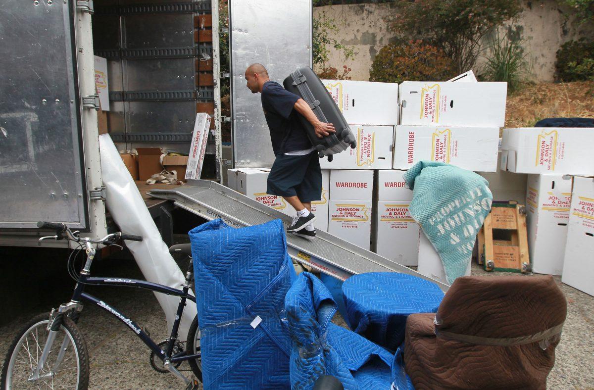 In this file photo, a worker moves a piece of furniture into a truck while moving a family in Tiburon, Calif., on Aug. 3, 2010. (Justin Sullivan/Getty Images)