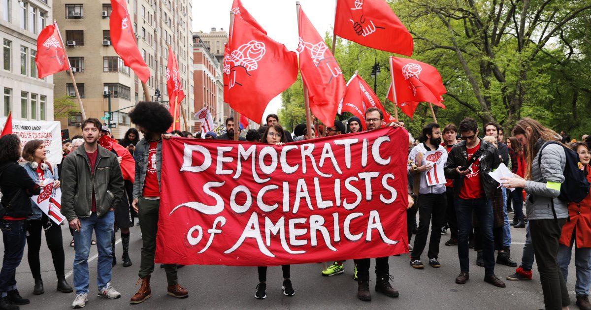  Members of the Democratic Socialists of America gather outside of a building owned by then-President Donald Trump in New York on May 1, 2019. (Spencer Platt/Getty Images)