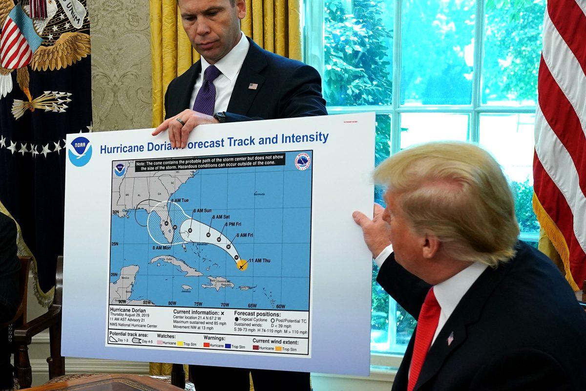 President Donald Trump, right, motions to a map held by acting Homeland Security Secretary Kevin McAleenan while talking to reporters following a briefing from officials about Hurricane Dorian in the Oval Office at the White House in Washington on Sept. 4, 2019. (Photo by Chip Somodevilla/Getty Images)