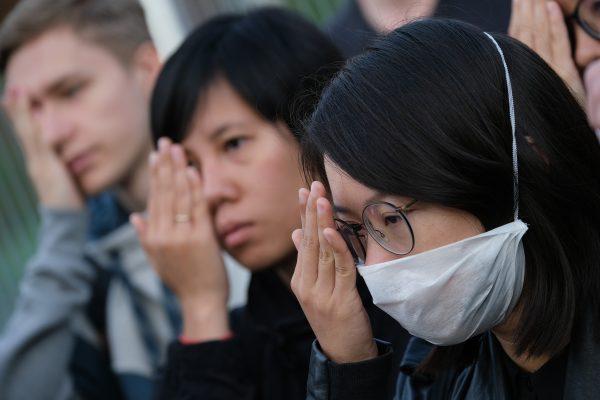Protesters standing outside the Chancellery cover one eye in reference to an injured demonstrator in Hong Kong as they urge German Chancellor Angela Merkel to show solidarity with pro-democracy demonstrations in Hong Kong on September 5, 2019 in Berlin, Germany. (Sean Gallup/Getty Images)