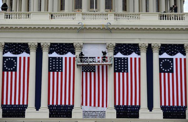 Two workers adjust U.S. flags on the U.S. Capitol as preparations continue for the second inauguration of President Barack Obama in Washington on Jan. 17, 2013. (Jewel Samada/AFP/Getty Images)