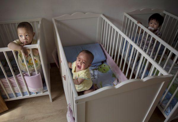 Young orphaned Chinese children are seen in cribs at a foster care center on April 2, 2014 in Beijing, China. (Kevin Frayer/Getty Images)