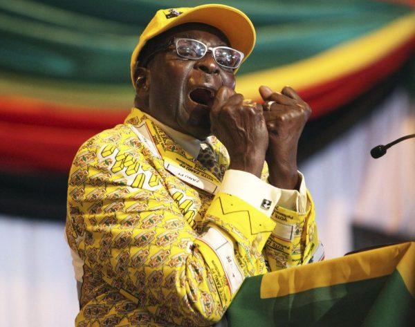 In this Friday, Dec. 7, 2012 file photo Zimbabwean President Robert Mugabe clenches his fists as he delivers his speech at his party's 13th annual conference, in Gweru. (AP Photo/Tsvangirayi Mukwazhi, File)