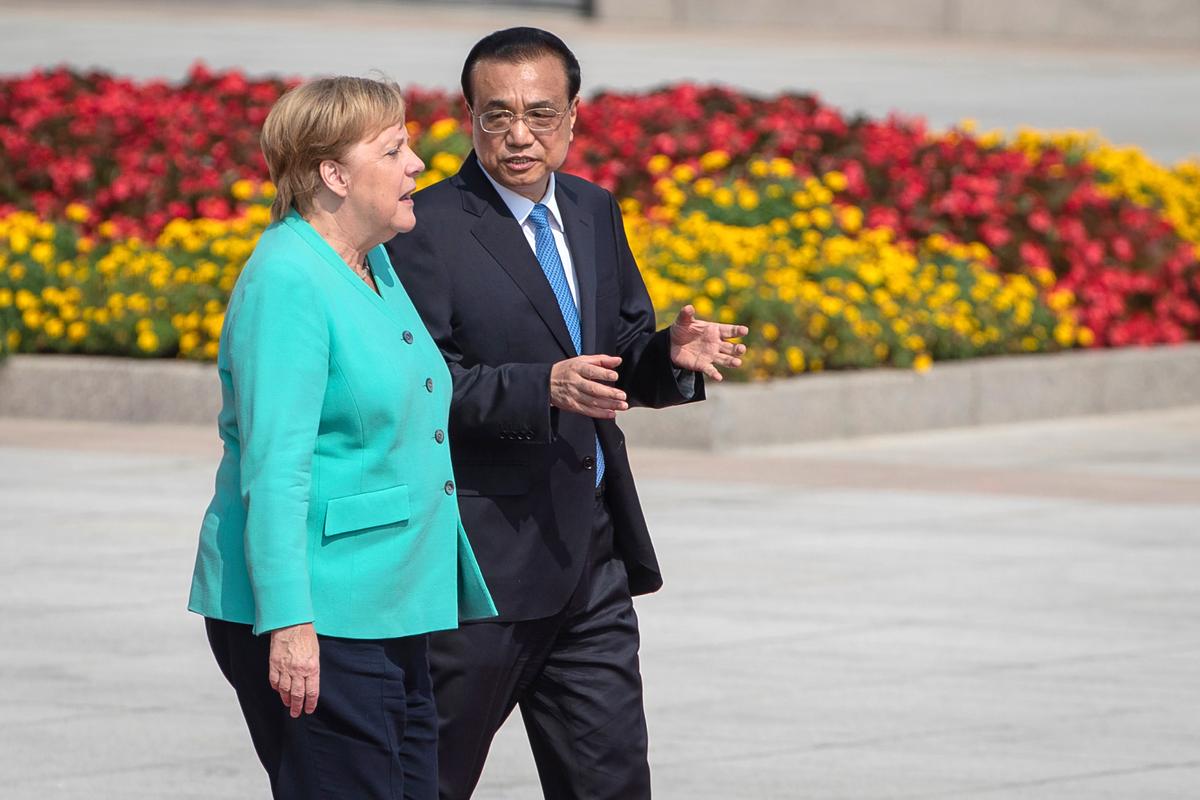 Chinese Premier Li Keqiang, right, and German Chancellor Angela Merkel attend a welcome ceremony at the Great Hall of the People in Beijing, China on Sept. 6, 2019. Merkel visits China from Sept. 6-7, 2019. (Roman Pilipey/Pool Photo via AP)