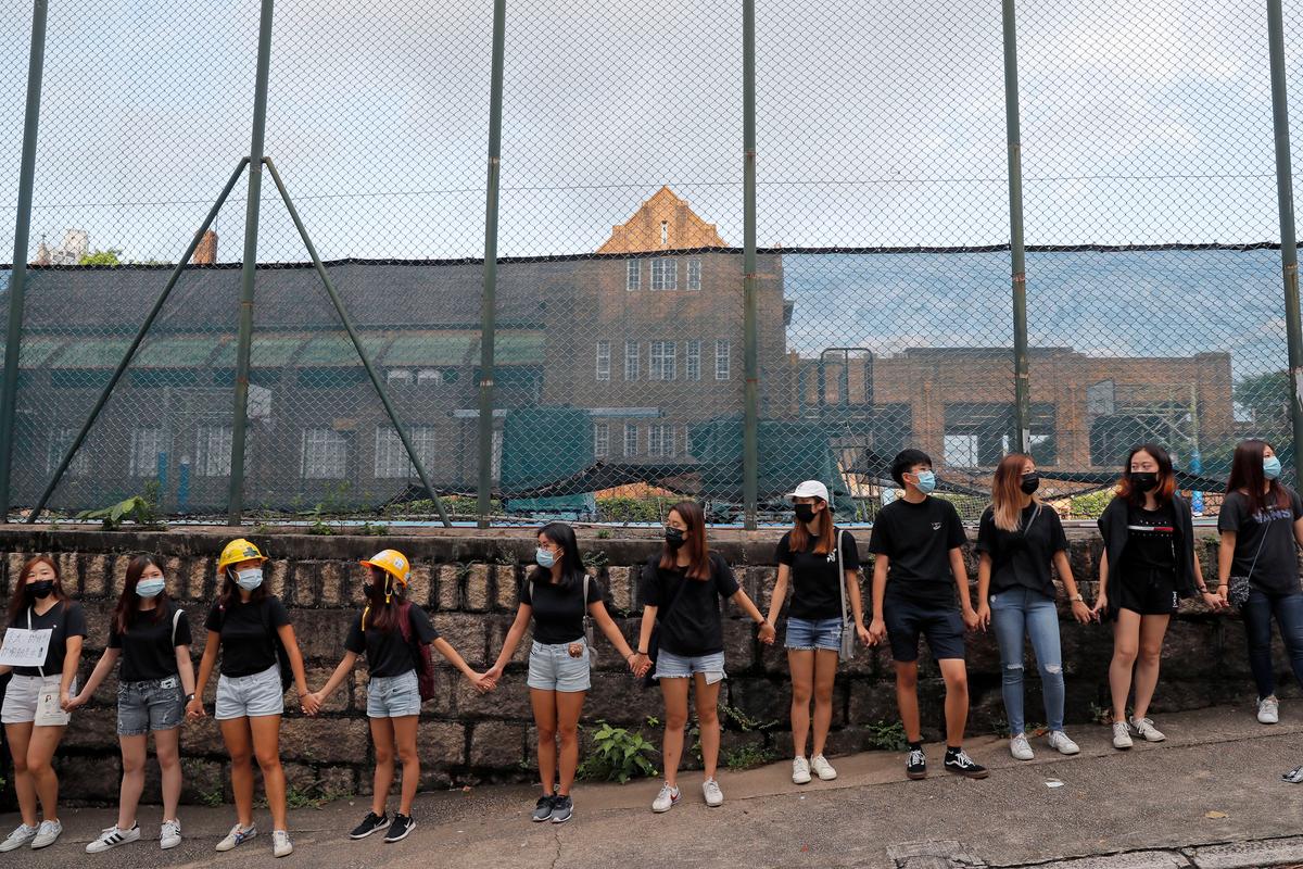 People form a human chain outside the Maryknoll Convent School in Hong Kong on Sept. 6, 2019. (Kin Cheung/AP)