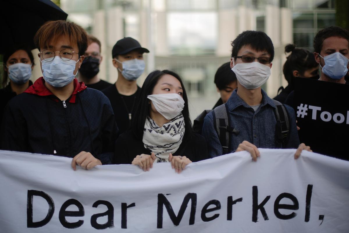 Protestors cover their right eye during a rally against the violence in Hong Kong and the Chinese regime, in front of the chancellery in Berlin, Germany on Sept. 5, 2019. The protestors demand the support of German Chancellor Angela Merkel for the protest movement in Hong Kong. (Markus Schreiber/AP)