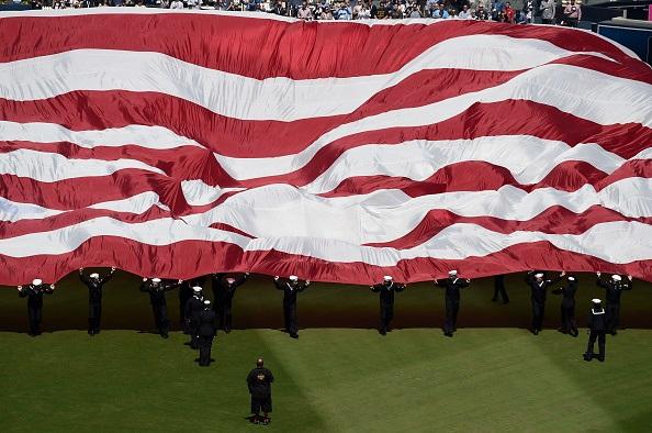 U.S. Navy sailors bring a giant American flag onto the field before the game between the San Diego Padres and the San Francisco Giants on Opening Day at Petco Park in San Diego, Calif., on March 28, 2019. (Denis Poroy/Getty Images)