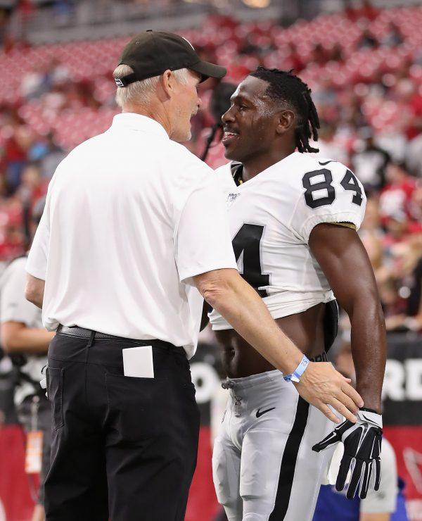Wide receiver Antonio Brown #84 of the Oakland Raiders talks with general manager Mike Mayock before the NFL preseason game in Glendale, Ariz., on Aug. 15, 2019. (Christian Petersen/Getty Images)