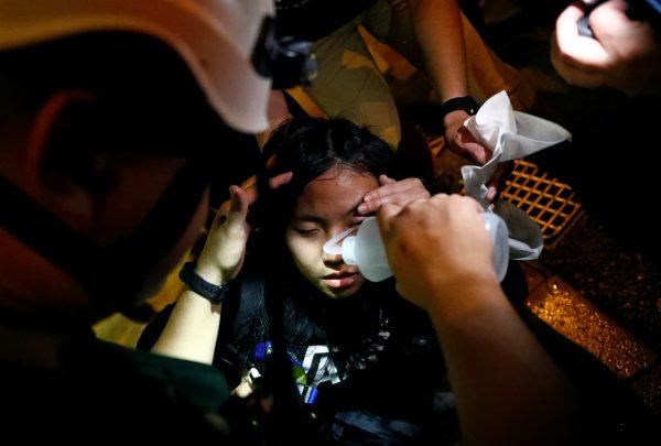 A woman gets first aid near Mong Kok police station in Hong Kong on Sept. 7, 2019. (Kai Pfaffenbach/Reuters)