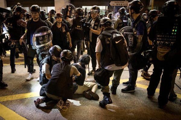 A woman is arrested by police after residents and protesters gathered outside the Mong Kok Police station in Hong Kong, on Sept. 07, 2019. (Chris McGrath/Getty Images)