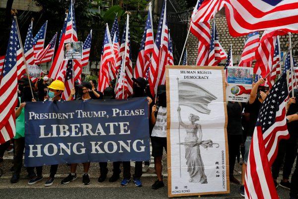 Protesters hold signs and U.S. flags during a rally in Hong Kong, China, on Sept. 8, 2019. (REUTERS/Anushree Fadnavis)