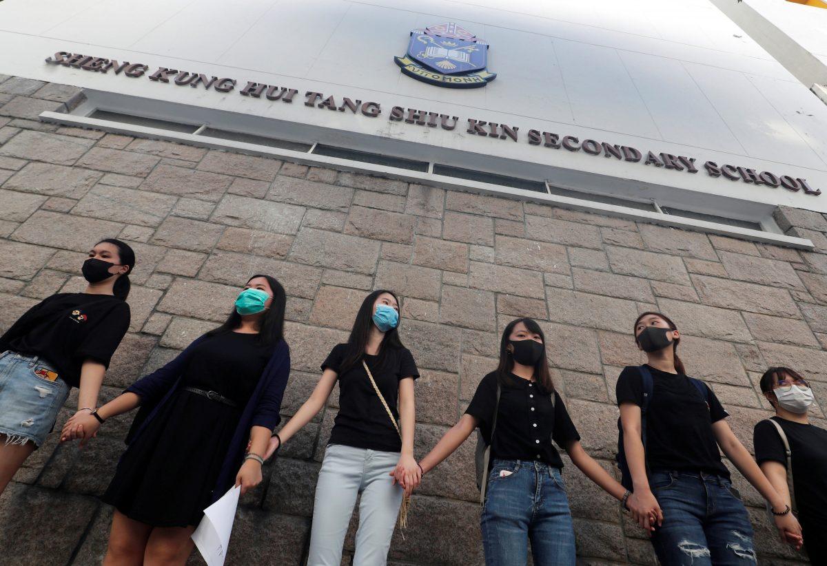 Activists join secondary schools students as they form a human chain demonstrating against what they say is police brutality against protesters, after clashes at Wan Chai district in Hong Kong, on Sept. 9, 2019. (Amr Abdallah Dalsh/ Reuters)