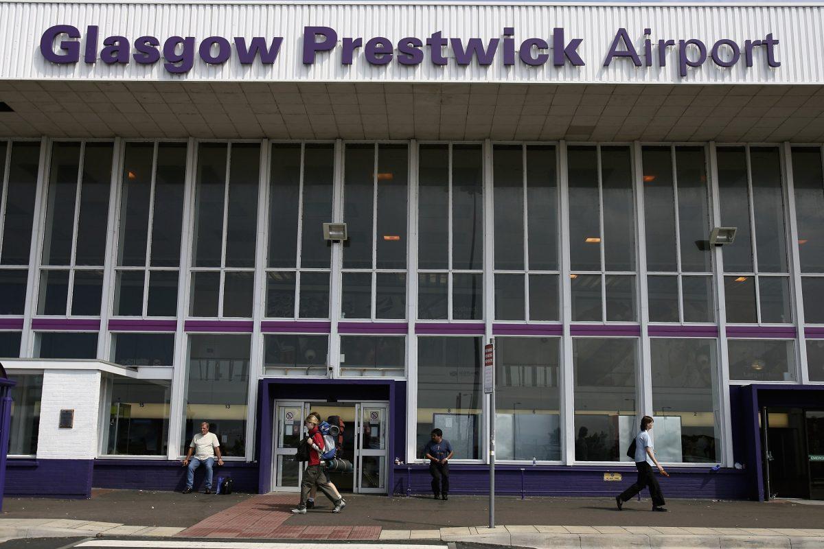 People walk past the entrance to Prestwick Airport in a file photograph. (Jeff J. Mitchell/Getty Images)