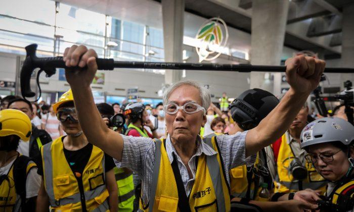 A Group of Parents and Elderly Protect Hong Kong Protesters During Police Clashes