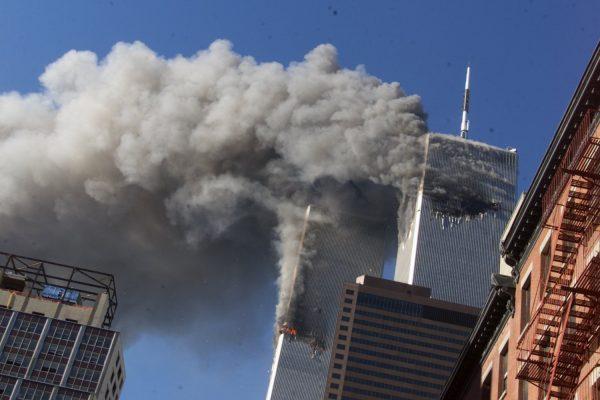 Smoke rises from the burning twin towers of the World Trade Center after hijacked planes crashed into the towers, in New York City on Sept. 11, 2001. (Richard Drew/AP)