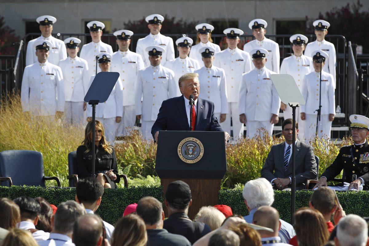 President Donald Trump speaks during a ceremony in observance of the 18th anniversary of the September 11th attacks at the Pentagon in Washington as First Lady Melania Trump, left, and Secretary of Defense Mark Esper, right, watch on Sept. 11, 2019. (AP Photo/Patrick Semansky)