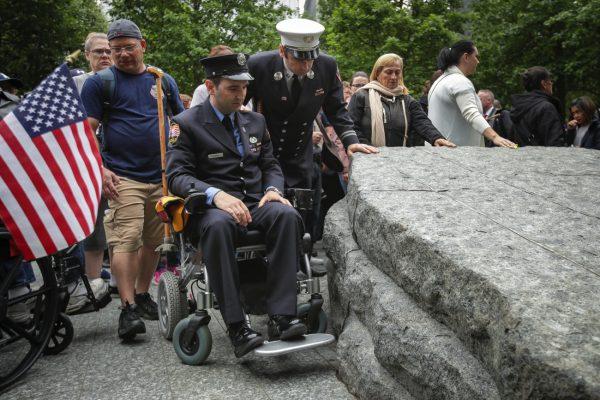 Retired FDNY firefighter and 9/11 first responder Rob Serra pauses at one of the stone monoliths following the dedication ceremony for the new 9/11 Memorial Glade at the National Sept. 11 Memorial in New York on May 30, 2019. (Drew Angerer/Getty Images)